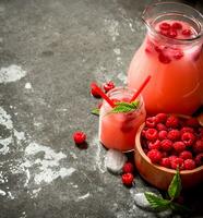 Raspberry juice with the berries and ice. photo