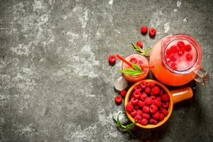 Raspberry juice with the berries and ice. photo