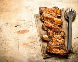 Pork ribs grilled on the Board. photo