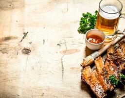 Barbecue pork ribs with tomato sauce and beer. photo