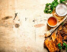 Barbecue pork ribs with tomato sauce and beer. photo