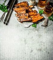 Smoked barbecue ribs with beer and herbs. photo