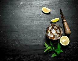 glass of rum with lime and mint. photo