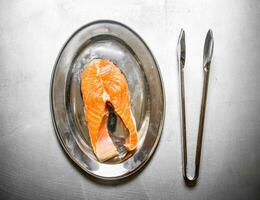 piece of raw salmon on a tray. photo