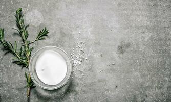 Salt with a branch of rosemary. photo