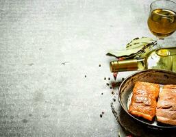 White wine with a grilled salmon fillet. photo
