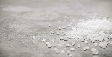 Coarse salt. On stone background. photo