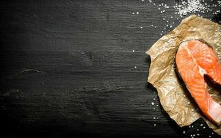 piece of raw salmon with salt. photo