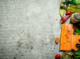 Salmon fillet with tomatoes, olive oil and spices. photo