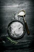 Salt and branches of rosemary photo