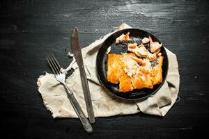 Fried salmon with spices in a bowl. photo