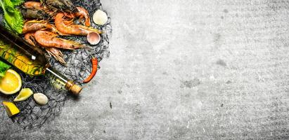 Fresh shrimp with a bottle of white wine photo