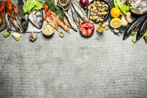 Different fish, shrimp and shellfish with slices of lemon photo