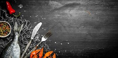 Fresh fish and shellfish on a fishing net. photo