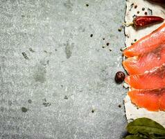 Thin slices of salmon on the old fabric. photo