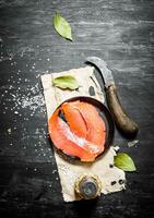 Smoked salmon slices with spices and salt. photo