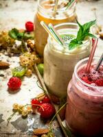 Berry smoothie made from currants, gooseberries and raspberries with nuts. photo