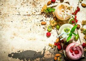 Berry smoothie made from currants, gooseberries and raspberries with nuts. photo