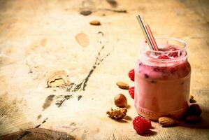 Raspberry smoothie with nuts. photo