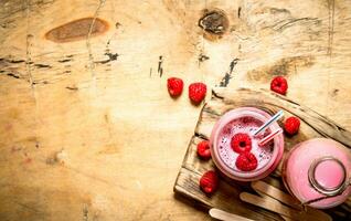 Berry smoothie raspberry with wooden sticks. photo