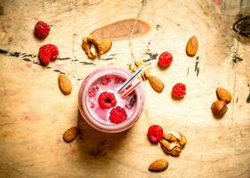 Raspberry smoothie with nuts. photo