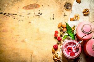 Raspberry smoothie with berries, mint and nuts. photo