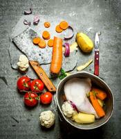 Cutting vegetables for chicken soup. photo