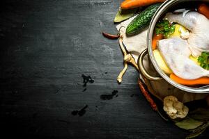 Not boiled chicken soup with fresh vegetables and spices. photo