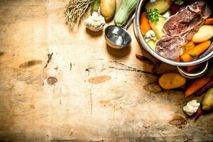 big pot of soup with beef and fresh vegetables. photo