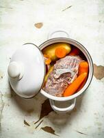 The pot of soup from meat and vegetables. photo