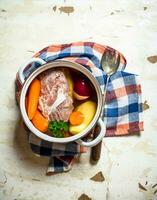 big pot of soup with meat and fresh vegetables. photo