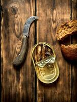 Smoked sprats with rye bread. photo