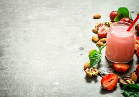 Strawberry smoothie with mint and nuts. photo