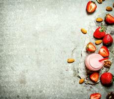 Strawberry smoothie with milk and nuts. photo
