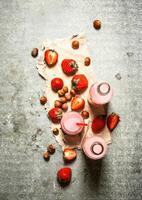 Strawberry juice with nuts on the old fabric. photo