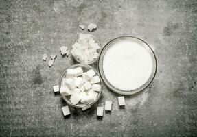 Different types of white sugar in a glass . photo