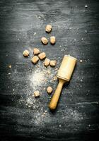 Brown cane sugar with pestle. photo