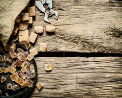 Cane sugar. On wooden background. photo