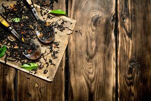 dried tea with spoons. photo