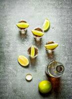 bottle of tequila with lime and salt. photo