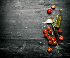 Fresh tomatoes with olive oil and a spoon of salt. photo