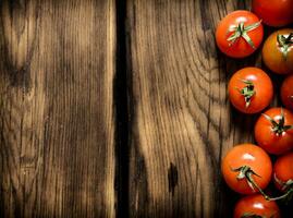 Fresh red tomatoes . On wooden background. photo