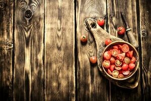 Cut fresh tomatoes in a wooden bowl. photo