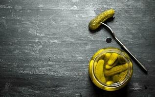 Pickled gherkins in a jar. photo