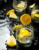 Glasses with vodka and lemon. photo