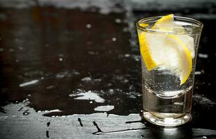 Glass with vodka and lemon. photo