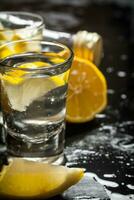 Glasses with vodka and lemon. photo