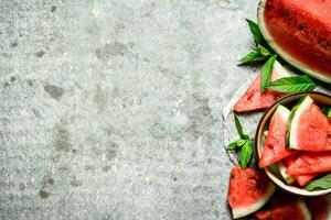 Pieces of watermelon in a bowl with mint. photo