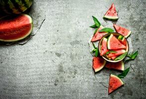 Pieces of watermelon in a bowl with mint. photo