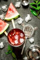 Watermelon cocktail with ice in a shaker. photo